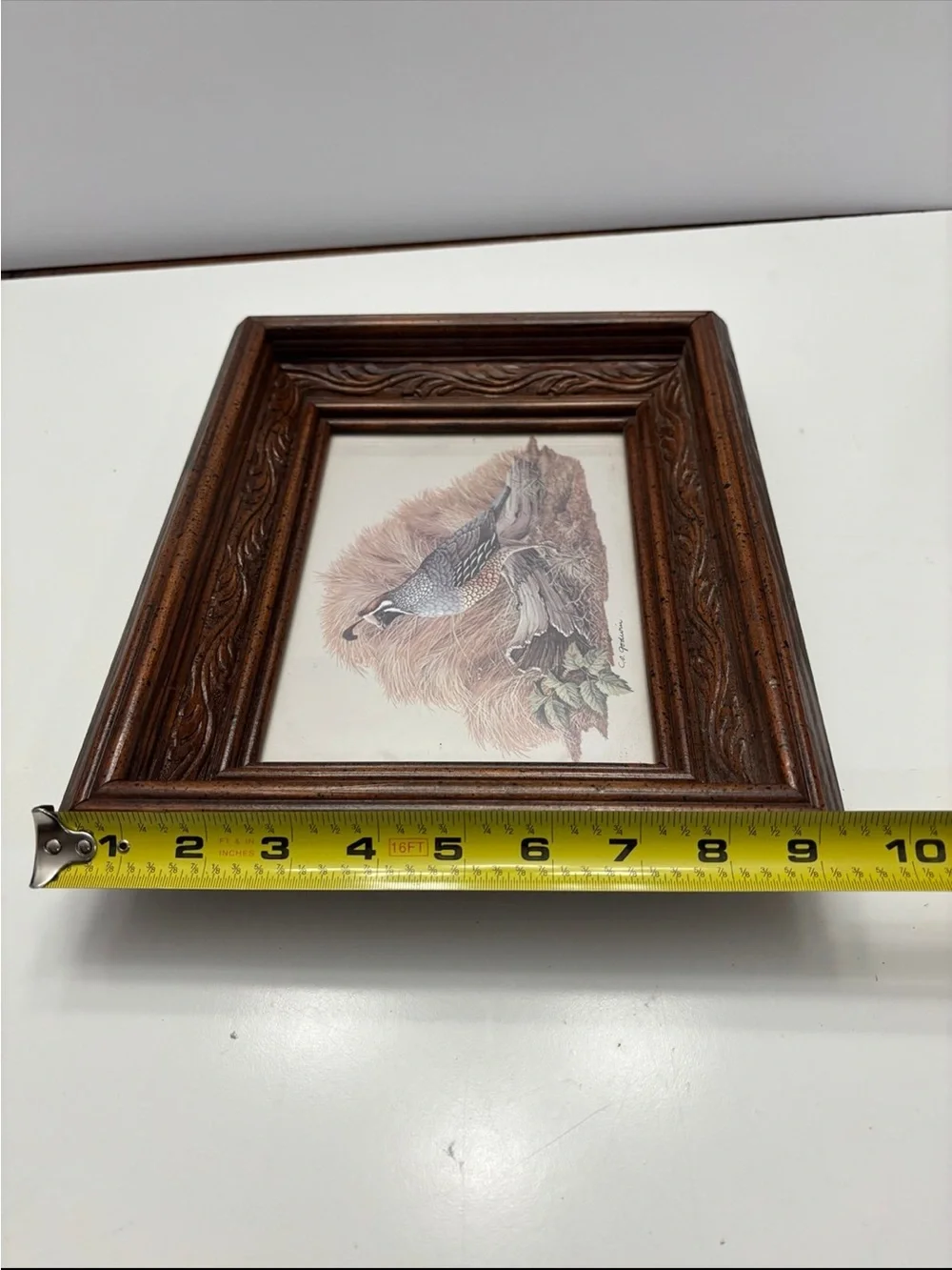 Vintage quail wall art with a rustic, carved wood frame